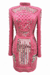 Pink dress with intricate beadwork and embroidery on a white background