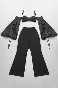 Conjunto de dos piezas negro con tirantes y mangas abullonadas, top corto, pantalones anchos de cintura alta
